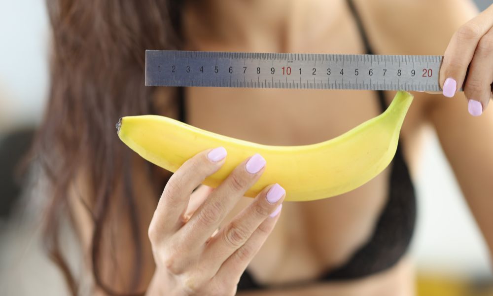 Woman measuring banana with a ruler